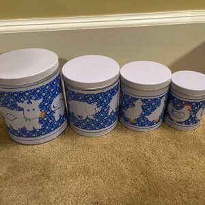 Set of 4 metal nesting canisters with blue and white farm animal design
